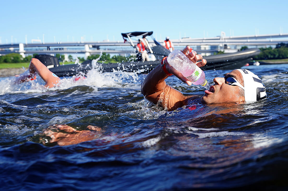 Oussama Mellouli drinking water while participating in the marathon swimming event at the Tokyo 2020 Olympics.