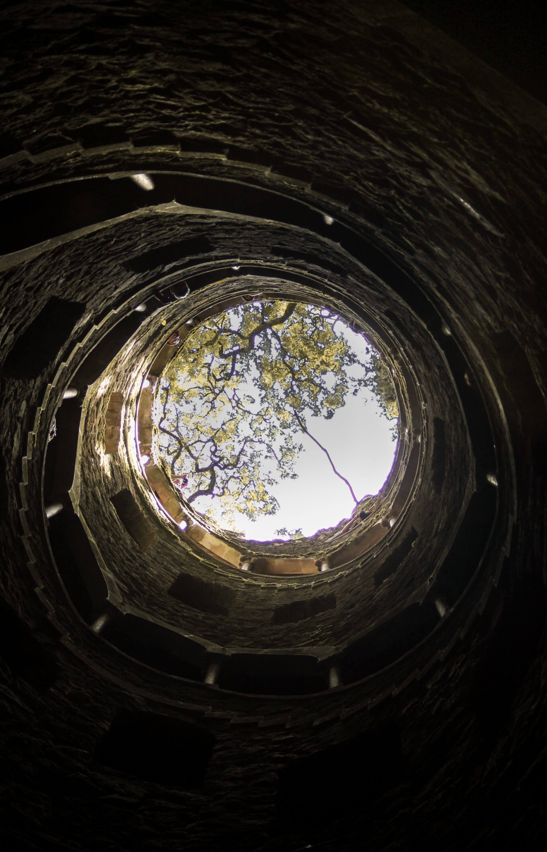 A view from the bottom of a well looking to the sky.
